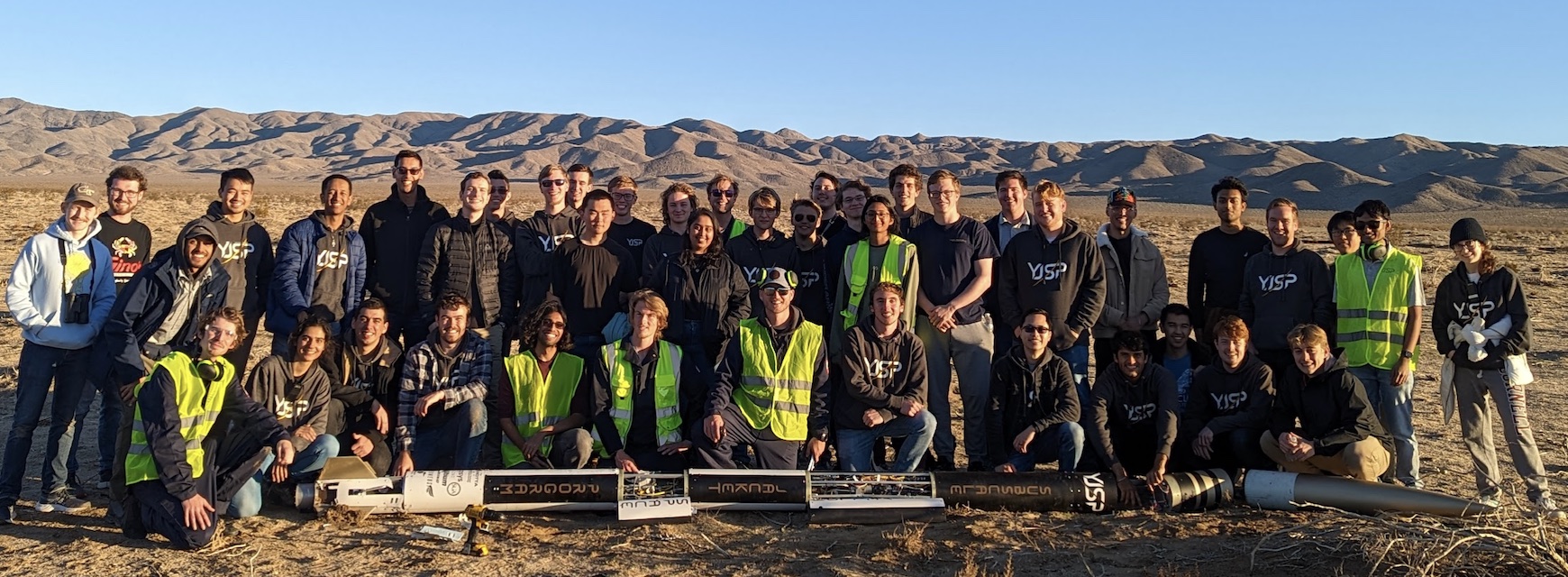 YJSP crew poses with their rocket after launch in the Mojave Desert 