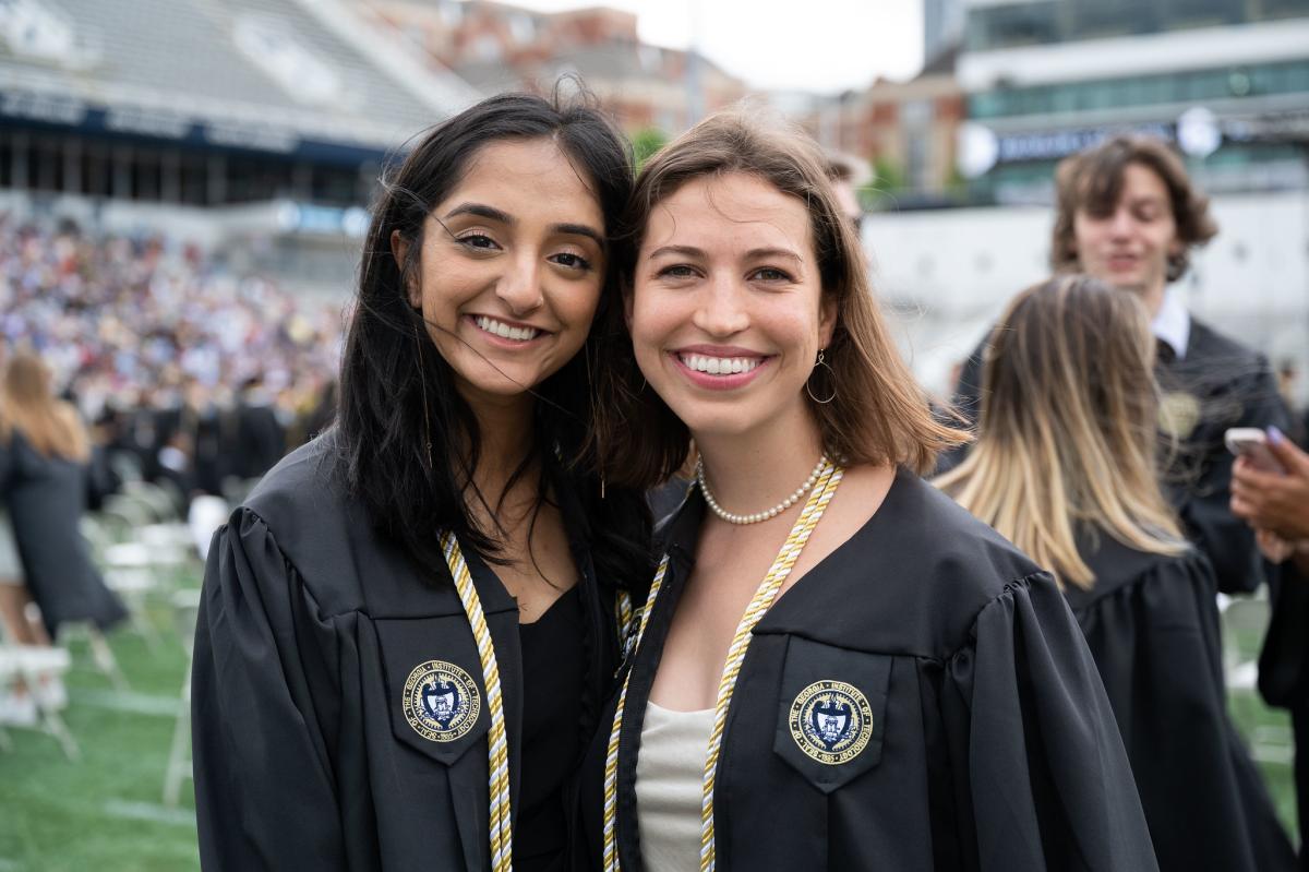 Two students smiling at graduation